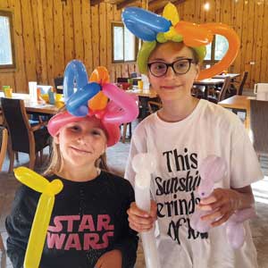 children wearing fun balloon hats