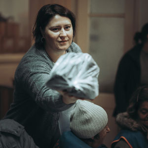 Erika Sabljov distributes shoes at Hand For a Friend