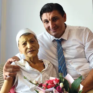 Dr. Beni Paul with a hospice patient on her baptism day.