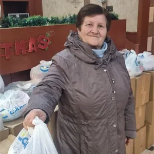 A lady with her food package in Albania