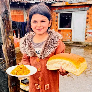 Girl with bread and soup in Bulgaria